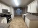 Spacious kitchen with white cabinets, dark countertops, and stainless steel appliances at 334 Royal Crescent Way, Stockbridge, GA 30281