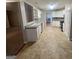 Well-lit kitchen with white cabinets, neutral countertops, stainless appliances and tiled backsplash at 334 Royal Crescent Way, Stockbridge, GA 30281