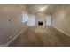 Spacious living room with fireplace, neutral carpet and gray walls and lots of natural light at 334 Royal Crescent Way, Stockbridge, GA 30281