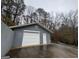 Detached garage with double doors and additional storage space at 9267 Westview Sw Dr, Covington, GA 30014