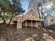 Home exterior with large, elevated deck and yard covered in mature trees at 4405 Cary Dr, Snellville, GA 30039