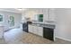Functional kitchen with white cabinets, dark appliances, and ample counter space at 4405 Cary Dr, Snellville, GA 30039