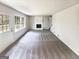 Large living area with a white stone fireplace and natural light from windows and door at 4405 Cary Dr, Snellville, GA 30039