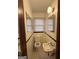 Cozy bathroom with a toilet, sink, mirror, and natural light at 1511 Walker Ave, College Park, GA 30337