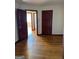 Spacious bedroom featuring hardwood floors, open doorway, and closet, showcasing a simple design at 1511 Walker Ave, College Park, GA 30337