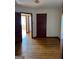 Bedroom with hardwood floors featuring an open closet space and access to additional rooms; ample space at 1511 Walker Ave, College Park, GA 30337