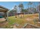 Fenced backyard featuring a covered patio, gazebo, storage shed, and green space for outdoor activities at 1406 Stone Ridge Ct, Hampton, GA 30228