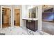Bathroom vanity, marble floors, walk-in shower and views into two walk-in closets at 1406 Stone Ridge Ct, Hampton, GA 30228