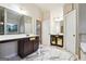 Dual sink vanity in a bathroom with marble floors, and granite countertops at 1406 Stone Ridge Ct, Hampton, GA 30228