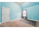 Bright bedroom with blue walls, plush carpet, natural light, and white trim at 1406 Stone Ridge Ct, Hampton, GA 30228