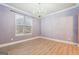 An empty bedroom illuminated by a stunning chandelier and natural light at 1406 Stone Ridge Ct, Hampton, GA 30228