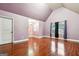A spacious room featuring a vaulted ceiling, hardwood floors, and large windows for natural light at 1406 Stone Ridge Ct, Hampton, GA 30228
