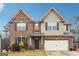 Charming two-story home featuring a brick and siding exterior with an attached two-car garage at 1406 Stone Ridge Ct, Hampton, GA 30228
