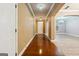 Inviting foyer with hardwood floors, a chandelier, and arched openings to adjacent living spaces at 1406 Stone Ridge Ct, Hampton, GA 30228