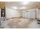 A spacious two car garage featuring concrete flooring, white walls, and a garage door opener at 1406 Stone Ridge Ct, Hampton, GA 30228