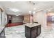 Open-concept kitchen with a center island, granite countertops, and views into the living room at 1406 Stone Ridge Ct, Hampton, GA 30228