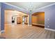 Open-concept living room with hardwood flooring, a chandelier, and arched openings at 1406 Stone Ridge Ct, Hampton, GA 30228