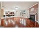 Open-concept living room with hardwood flooring leads to the bright kitchen at 1406 Stone Ridge Ct, Hampton, GA 30228