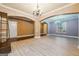 Open floor plan with multiple chandeliers and arched openings leading to other spaces at 1406 Stone Ridge Ct, Hampton, GA 30228