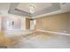 A large main bedroom with a tray ceiling and featuring lots of natural light and neutral carpeting at 1406 Stone Ridge Ct, Hampton, GA 30228