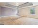 An expansive main bedroom with tray ceilings, lots of natural light, and space for a seating area at 1406 Stone Ridge Ct, Hampton, GA 30228