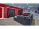 Finished basement with sectional sofa and red accent wall at 3423 Mulberry Lane Ct, Dacula, GA 30019