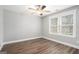 Minimalist bedroom featuring wood floors, a bright window, and neutral decor at 1714 Boulder Walk Se Ln, Atlanta, GA 30316