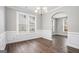 Dining room featuring elegant wainscoting, bright windows, and a classic chandelier at 1714 Boulder Walk Se Ln, Atlanta, GA 30316