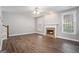 Bright living room featuring hardwood floors, a classic fireplace, and large windows at 1714 Boulder Walk Se Ln, Atlanta, GA 30316