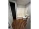 Updated bathroom with a tub, toilet, and wood-look flooring at 11684 Heritage Dr, Hampton, GA 30228