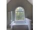 Bathroom with vaulted ceiling, large window, and garden tub at 11684 Heritage Dr, Hampton, GA 30228