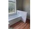 Bathroom with garden tub, shower, and laminate wood floor at 11684 Heritage Dr, Hampton, GA 30228