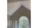 Bathroom with vaulted ceiling, large window, and garden tub at 11684 Heritage Dr, Hampton, GA 30228