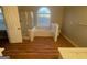 Bathroom with soaking tub, shower, and laminate wood floor at 11684 Heritage Dr, Hampton, GA 30228