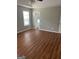 Spacious bedroom with ensuite bathroom access and laminate wood floor at 11684 Heritage Dr, Hampton, GA 30228