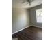 Bright bedroom with ceiling fan and dark laminate flooring at 11684 Heritage Dr, Hampton, GA 30228