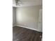 Spacious bedroom with dark laminate flooring and neutral walls at 11684 Heritage Dr, Hampton, GA 30228