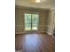 Dining room features a large window and laminate floor at 11684 Heritage Dr, Hampton, GA 30228