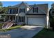 Two-story house with a large garage and front porch at 11684 Heritage Dr, Hampton, GA 30228