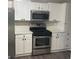 Stylish kitchen with white cabinets and stainless steel appliances at 11684 Heritage Dr, Hampton, GA 30228