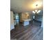 Open kitchen with island and hardwood floors at 11684 Heritage Dr, Hampton, GA 30228