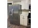 Modern kitchen with stainless steel appliances and white cabinets at 11684 Heritage Dr, Hampton, GA 30228