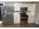 Updated kitchen with stainless steel appliances and white cabinets at 11684 Heritage Dr, Hampton, GA 30228