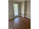 Bright living room featuring neutral walls and laminate flooring at 11684 Heritage Dr, Hampton, GA 30228