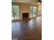 Spacious living room with fireplace and dark laminate floors at 11684 Heritage Dr, Hampton, GA 30228