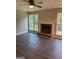 Living room features a brick fireplace and laminate flooring at 11684 Heritage Dr, Hampton, GA 30228