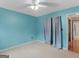 Bedroom with light teal walls, ceiling fan, and a view of another room at 330 Orleans Blvd, Mcdonough, GA 30253