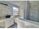 This bathroom features a soaking tub, bowl sink, and marble accents for a relaxing experience at 4284 Caroline Ct, Douglasville, GA 30135