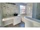 Bright bathroom featuring a bowl sink, tub, and modern marble accents creating a stylish look at 4284 Caroline Ct, Douglasville, GA 30135