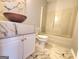 Bathroom featuring marble tiled walls and vanity with white toilet and tub at 4284 Caroline Ct, Douglasville, GA 30135